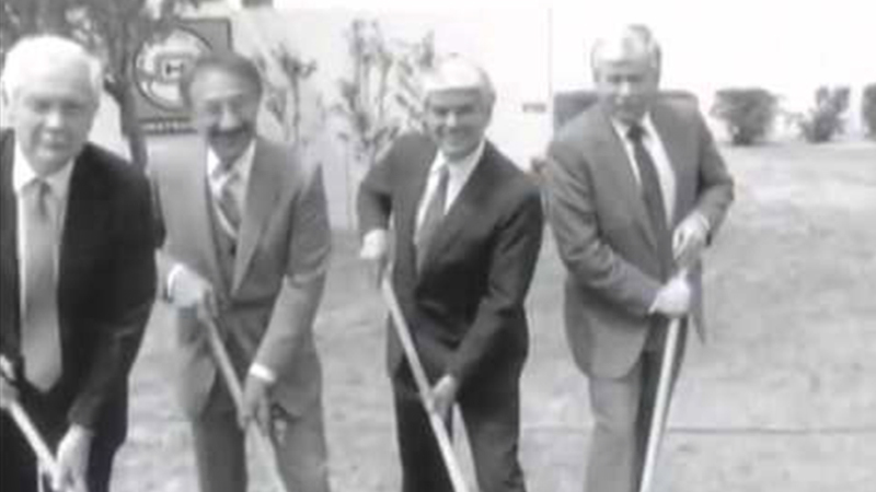 Black and white photo of four men with a shovel at the Proton Therapy groundbreaking