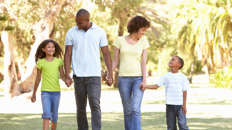 Parents and two kids out on a nature walk